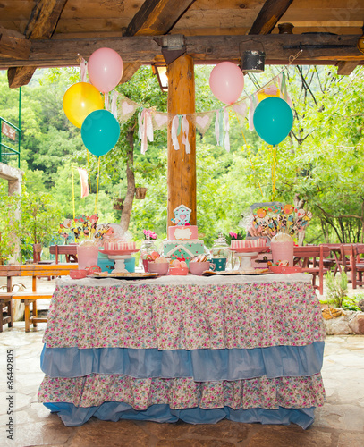 Prepared birthday table with sweets for children party photo