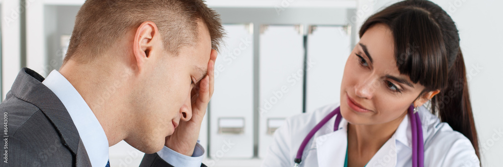 Fototapeta premium Concerned beautiful female medicine doctor listening carefully p