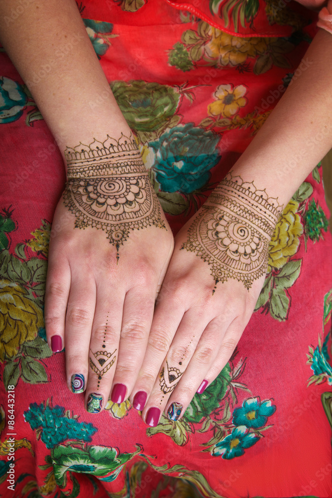
two hands with henna tattoos mehendi designs