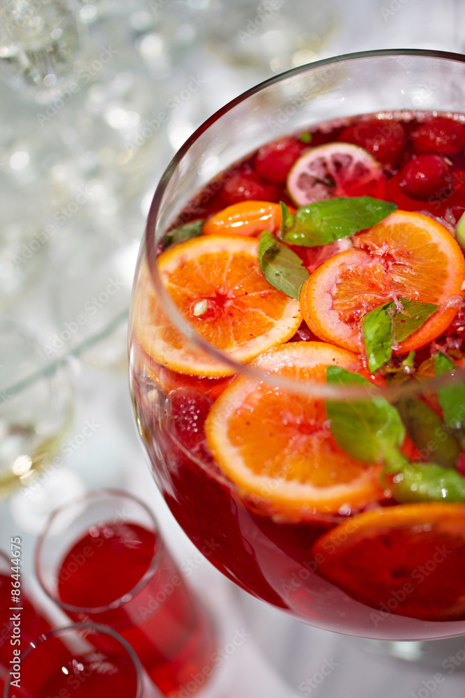 Red Lemonade cocktail with fresh orange on white background Red Lemonade cocktail with fresh orange on white background