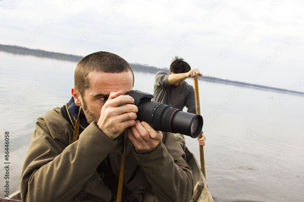 Obraz premium Men in boat on the river, shooting, adventure, real