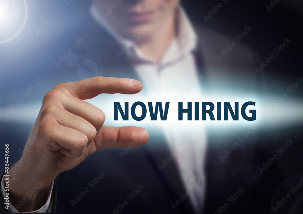 Businessman presses button now hiring on virtual screens. Busine Businessman presses button now hiring on virtual screens. Busine