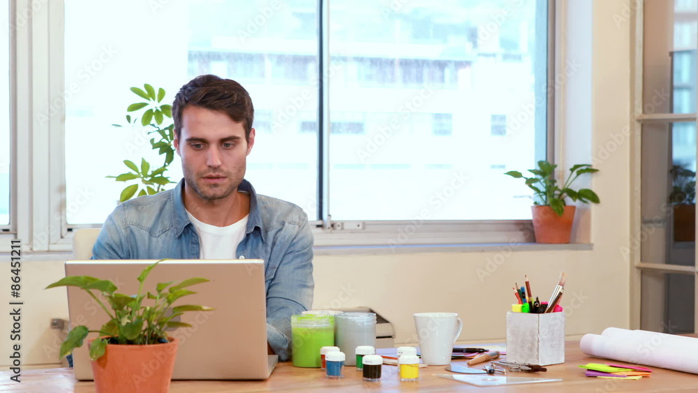 Casual businessman working on laptop computer Casual businessman working on laptop computer