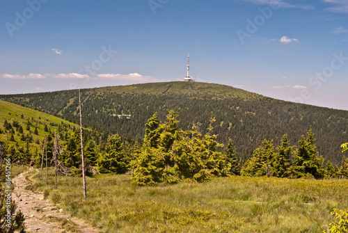 hiking trail with Praded hill on the background in Hruby Jesenik mountains photo