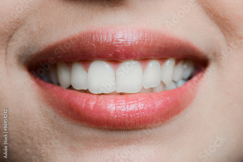 close-up of a beautiful woman mouth white teeth and glossy lips