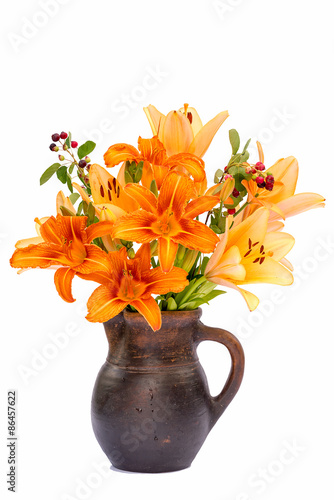 Fototapeta Naklejka Na Ścianę i Meble -  Asiatic Hybrids orange lilys bouquet in a brown vase isolated on white background