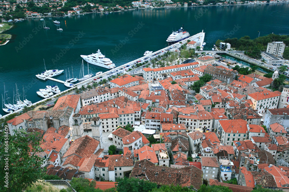 building red rooftops European town on the coast