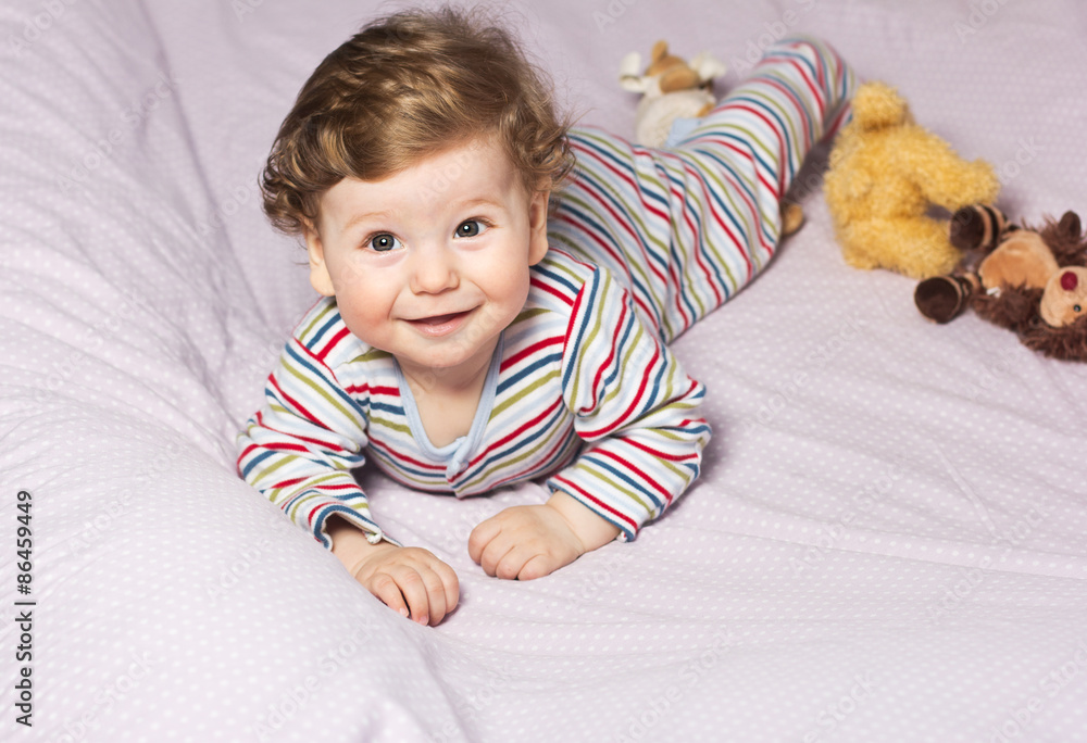 Beautiful baby with a lovely toys.The child in the crib
Beautiful baby with a lovely toys.The child in the crib