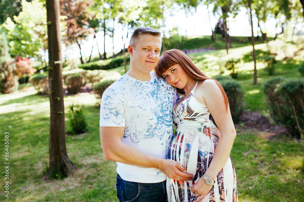 Pregnant couple in the park Pregnant couple in the park
