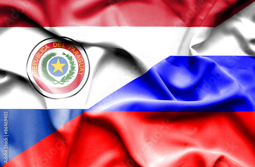 Waving flag of Russia and Paraguay
