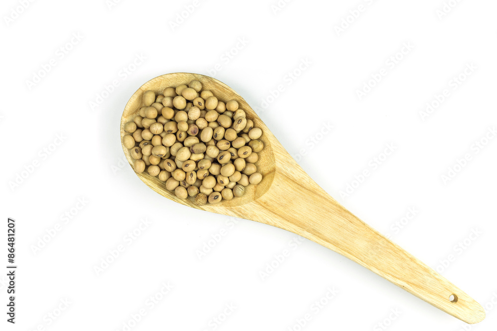 Soy beans in wooden spoon isolated on white Soy beans in wooden spoon isolated on white