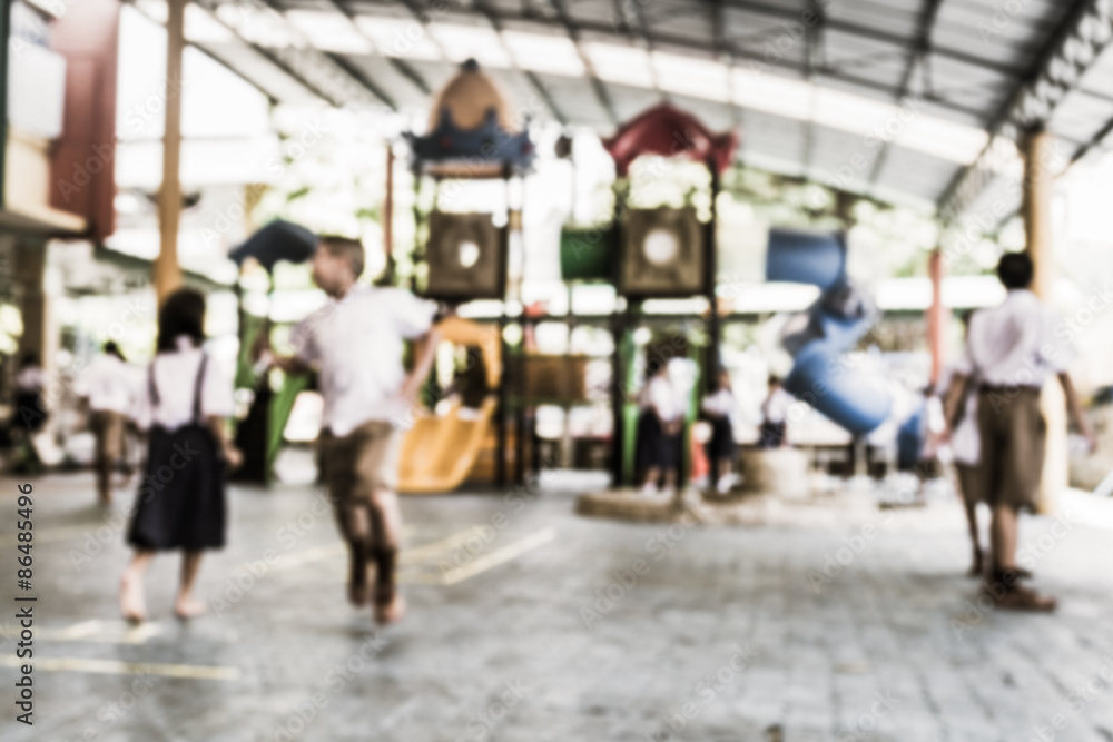 Fototapeta premium Blurred schoolchild are playing in the playground