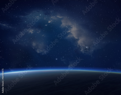 Blue planet with nebula on background.