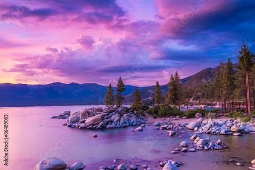 Sunset over Lake Tahoe with stormy clouds over sierra nevada mountains, dramatic sky