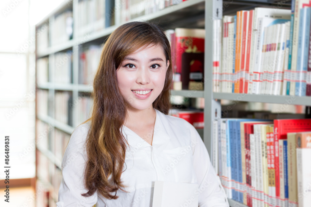 Asian beautiful female student portrait in library