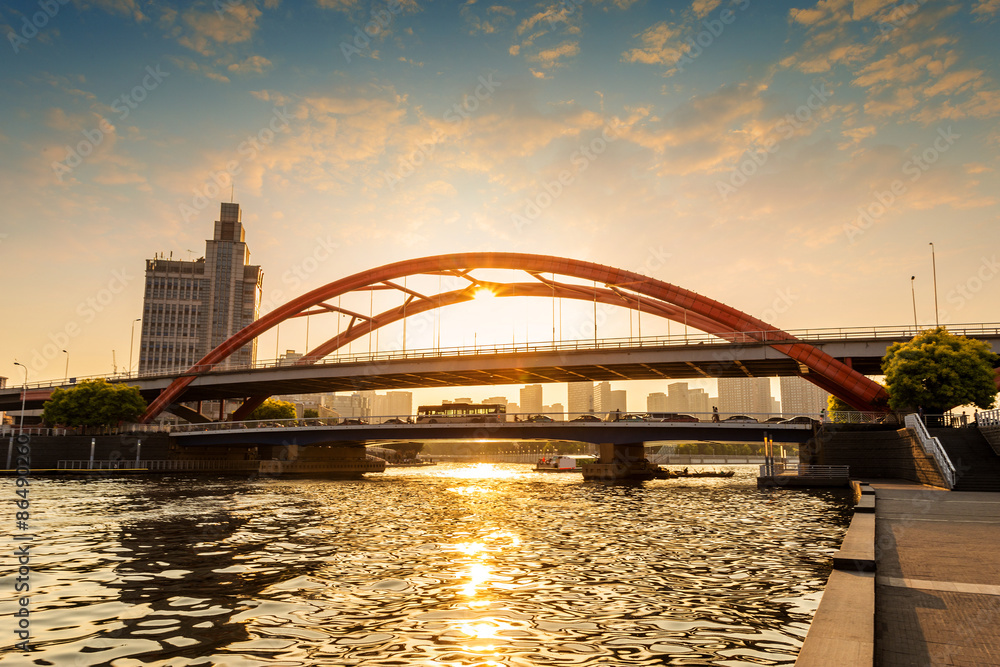 Obraz premium modern bridge over river at sunset