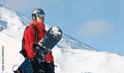 Male snowboarder with a board with copy space