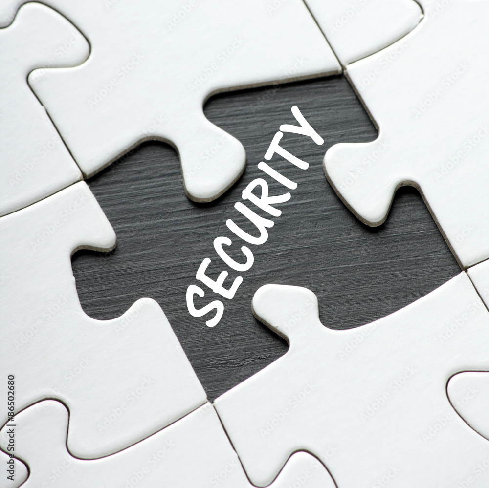 Fototapeta premium The word Security in white text revealed by a missing jigsaw puzzle piece