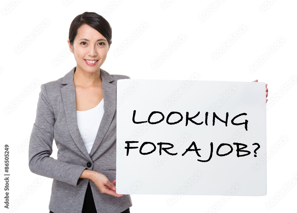 Beautiful businesswoman showing a placard showing with looking f