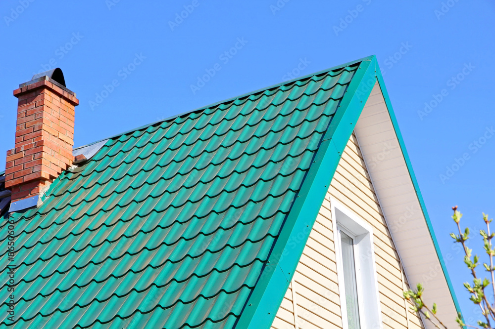 Mint color tiled roof and brick chimney.