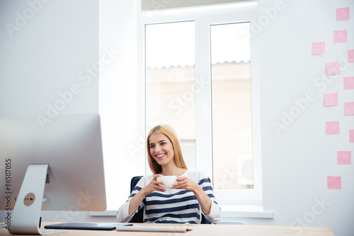 Female photo editor drinking coffee