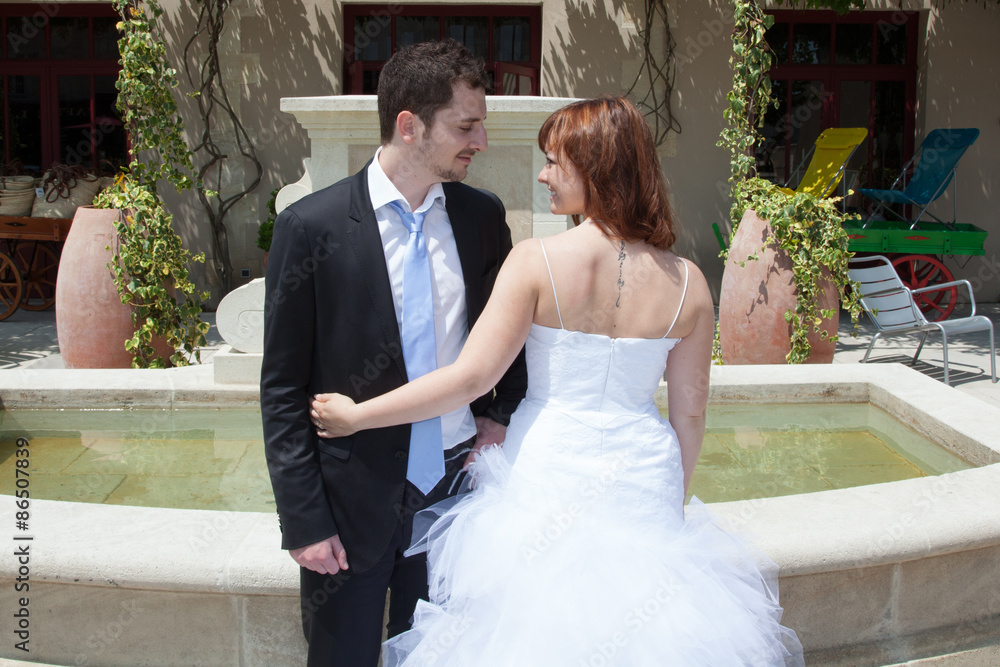 Beautiful newlywed couple outside looking at the camera Beautiful newlywed couple outside looking at the camera