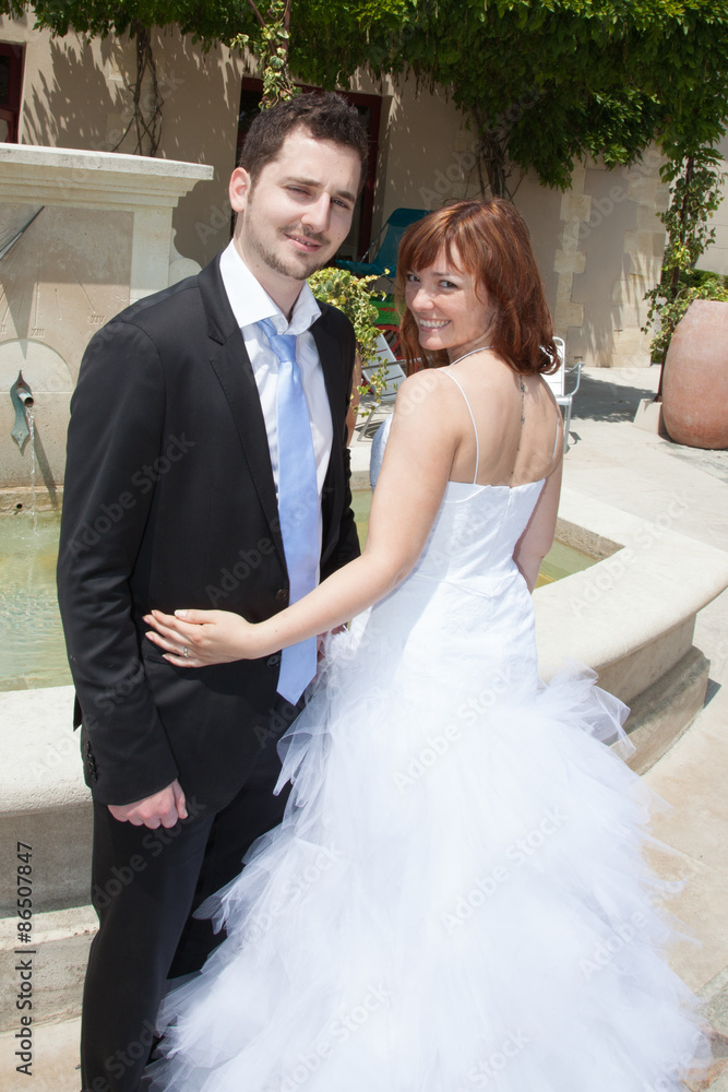 Beautiful newlywed couple outside looking at the camera Beautiful newlywed couple outside looking at the camera
