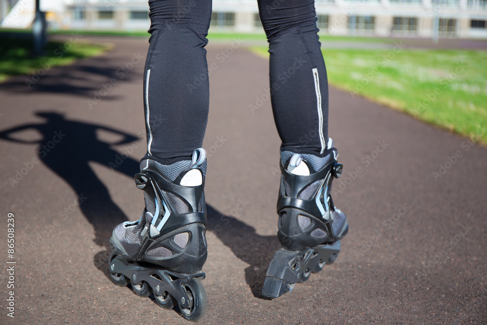 close up view of female legs in roller blades close up view of female legs in roller blades