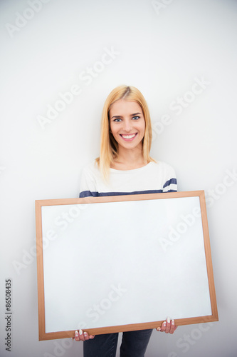 Beautiful girl holding blank board