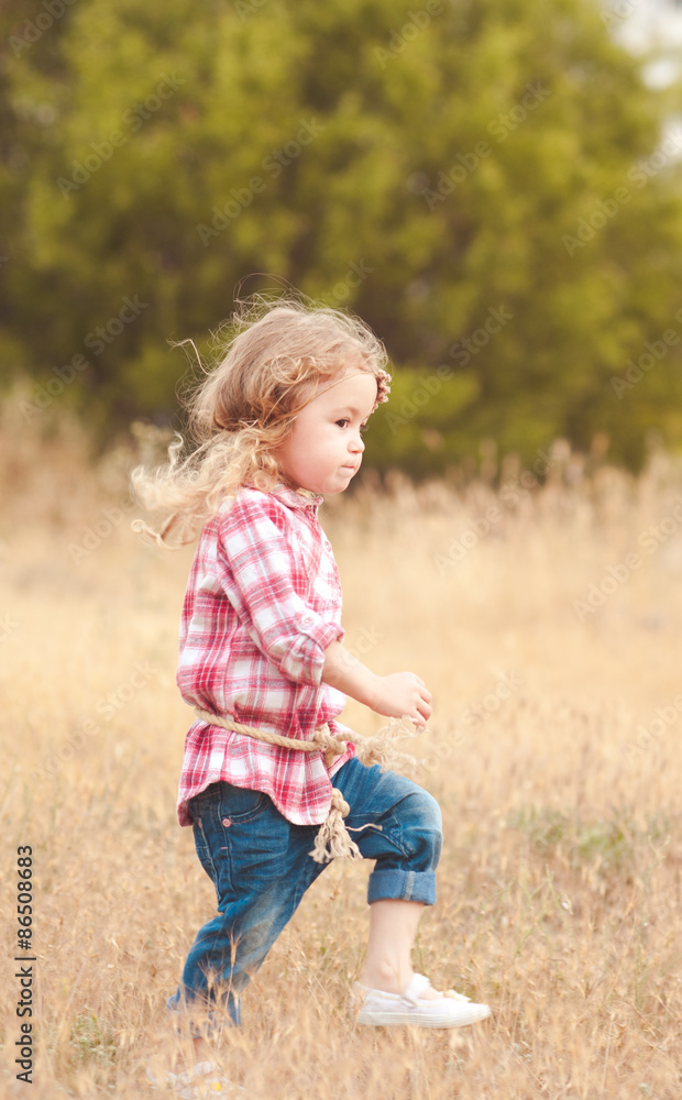 Stylish kid girl 2-3 year old walking in meadow. Childhood. Country side. Stylish kid girl 2-3 year old walking in meadow. Childhood. Country side.