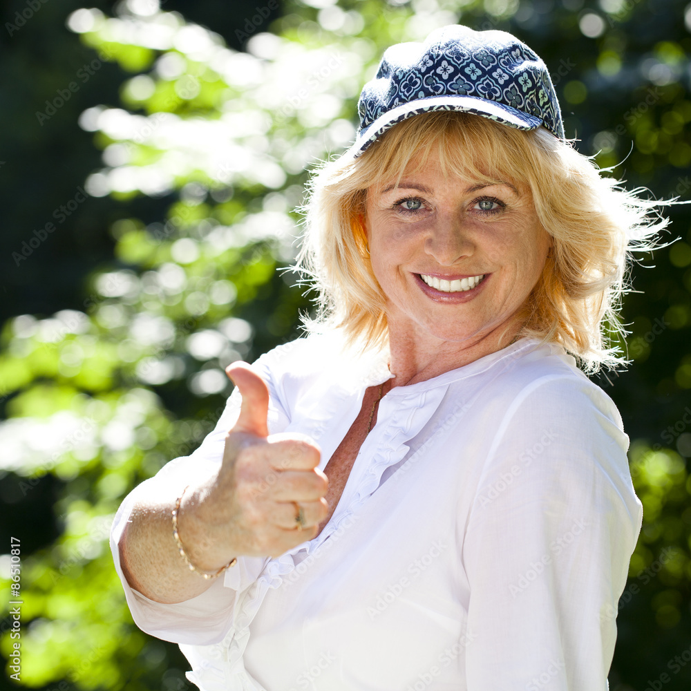 Portrait of lovely middle aged woman in the summer park Portrait of lovely middle aged woman in the summer park