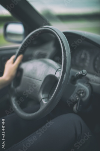 Woman's hand driving a car. Unrecognizable person. © M-Production