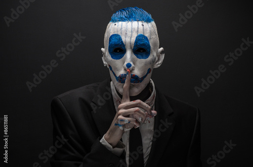Tela Terrible clown and Halloween theme: Crazy blue clown in black suit isolated on a