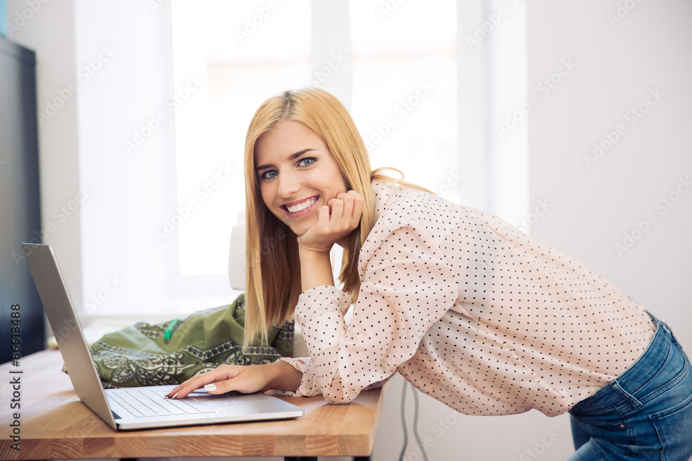 Smiling fashion designer using laptop Smiling fashion designer using laptop