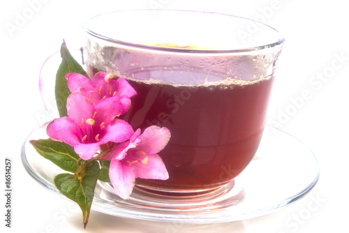 saturated bright fragrant tea with pink flowers