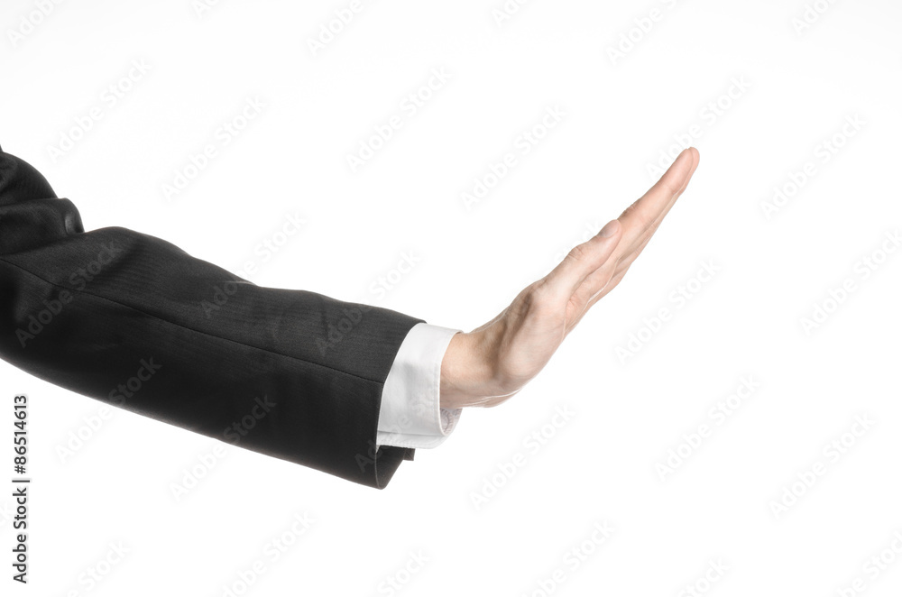 Businessman and gesture topic: a man in a black suit and white shirt showing hand gesture on an isolated white background in studio Businessman and gesture topic: a man in a black suit and white shirt showing hand gesture on an isolated white background in studio