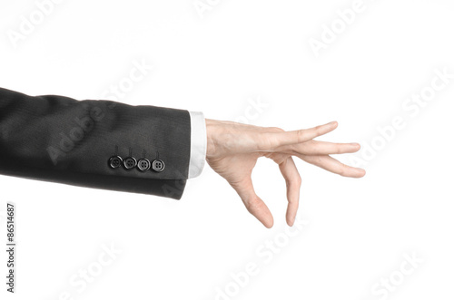 Businessman and gesture topic: a man in a black suit and white shirt showing hand gesture on an isolated white background in studio