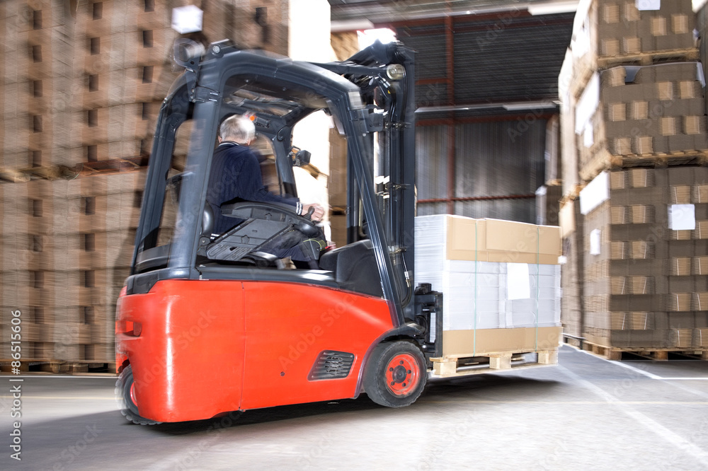 Worker Carrying Stock On Forklift