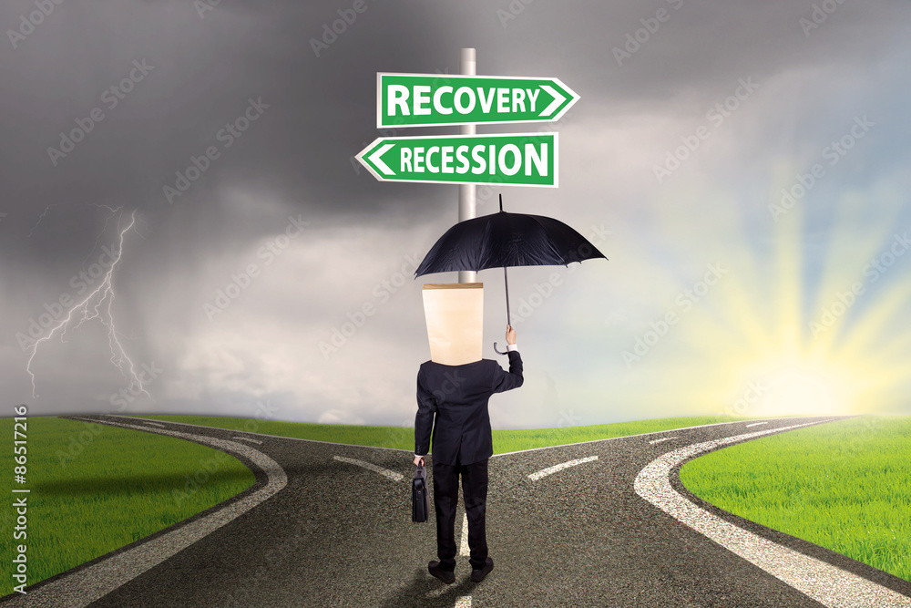 Businessperson with signboard to recovery or recession financial Businessperson with signboard to recovery or recession financial