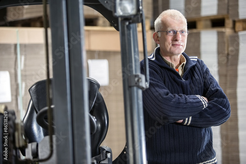 Confident Worker Leaning On Forklift