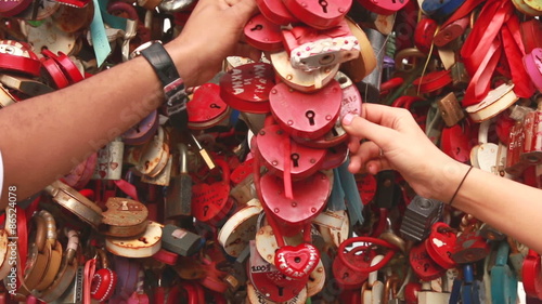 Hands touches red love locks