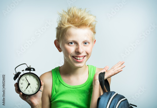 Teenager with an alarm clock