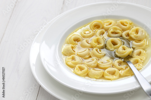 Photography tortellini in brodo, ring shaped pasta in broth, italian emilia romagna soup cui