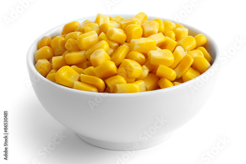 Bowl of tinned sweetcorn isolated on white. photo