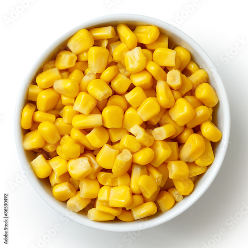Bowl of tinned sweetcorn isolated from above on white.