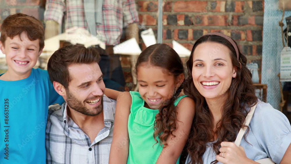 Happy family looking at camera in shopping mall Happy family looking at camera in shopping mall
