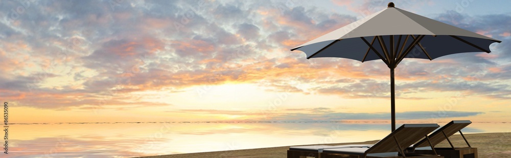 Deck Chairs and umbrella in sunset on the beach
