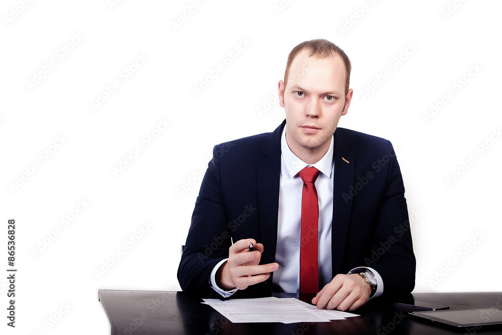 Businessman in red tie at the table gives a pen to sign Businessman in red tie at the table gives a pen to sign