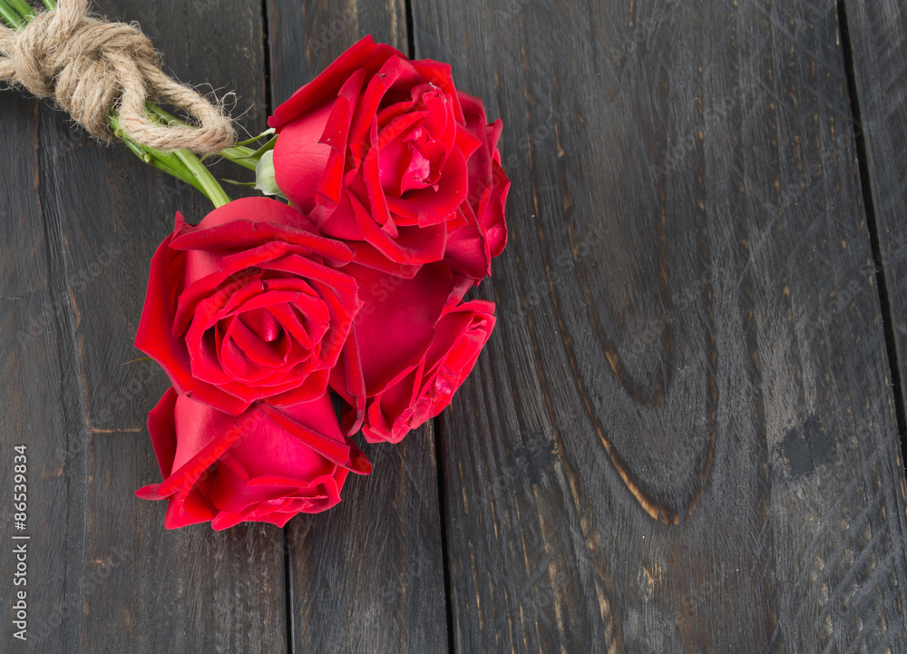 red rose bouquet on wood background red rose bouquet on wood background