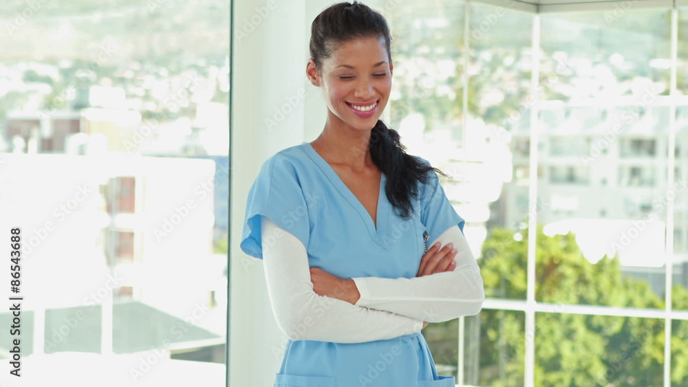 Smiling doctor with arms crossed looking at camera Smiling doctor with arms crossed looking at camera